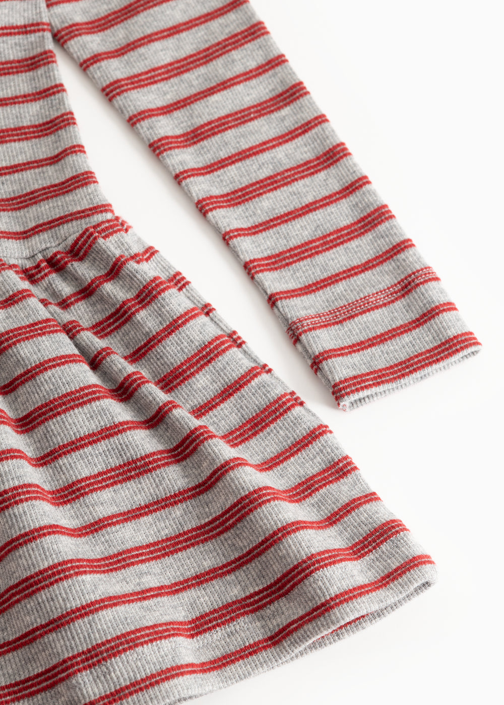 Detail of red and white striped fabric with gathered hem