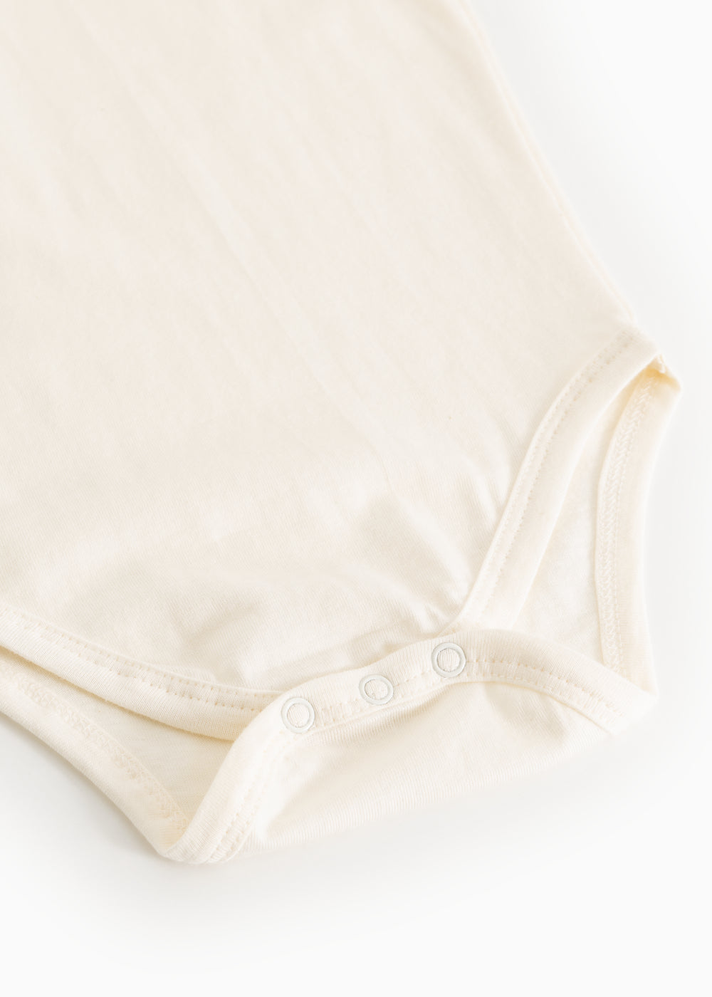 White bodystocking with snap buttons at the crotch and seam at the leg opening
