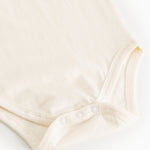 White bodystocking with snap buttons at the crotch and seam at the leg opening