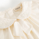 Offwhite blouse with embroidered collar edge and soft V-neckline in front
