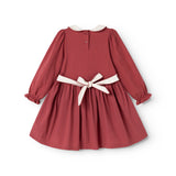 Burgundy dress with white collar trim and tie bow at the waist, long puff sleeves.