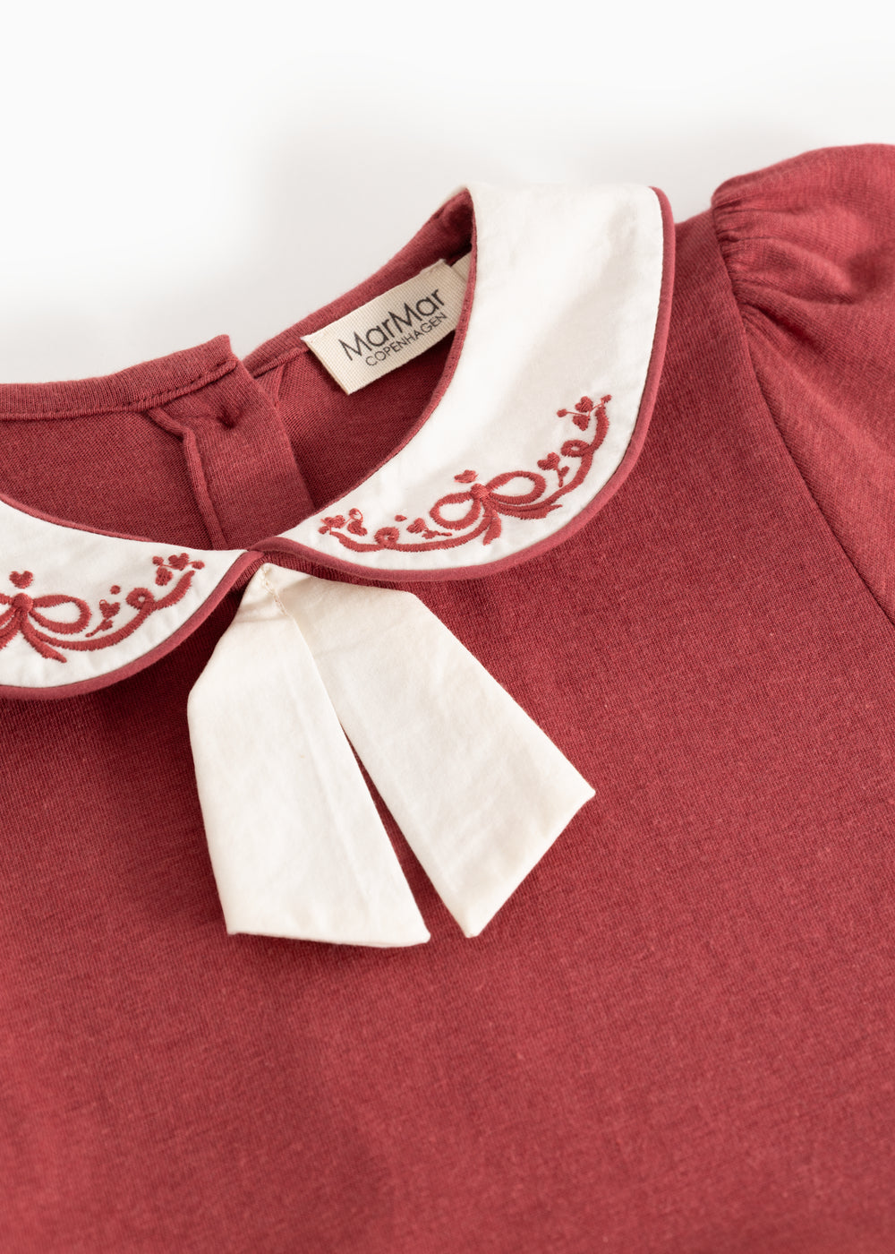 Red dress with white collar, red and white embroidery, and MarMar label inside.