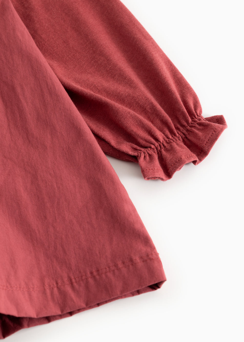 Red dress with long puff sleeves and elastic cuffs, slightly gathered hem at the bottom.