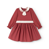 Burgundy dress with white collar, embroidery and bow detail, long puff sleeves.
