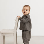 Child wearing a dark pied-de-poule Totoro shirt with long pants