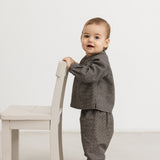 Children's houndstooth trousers with elastic waistband and straight, loose legs.