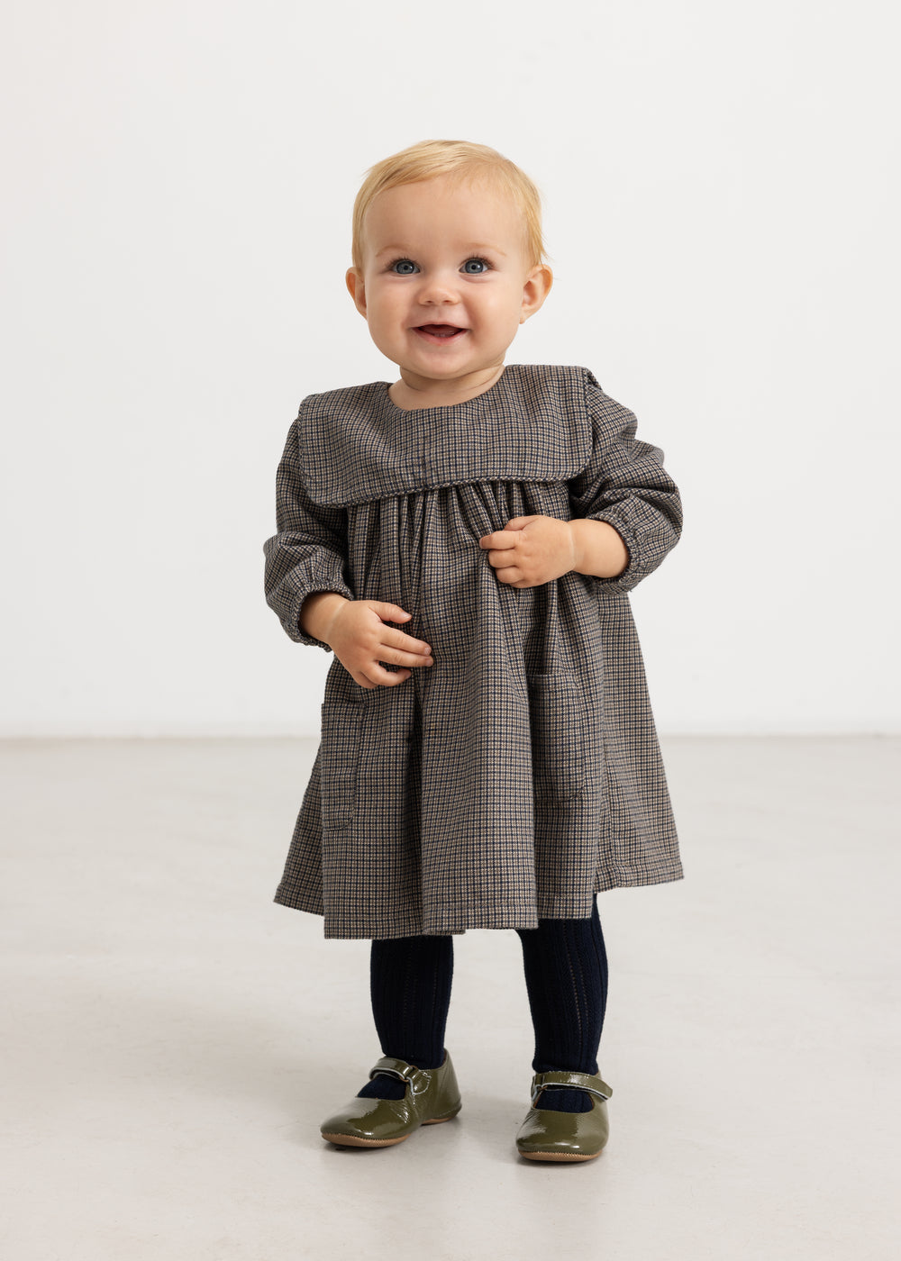 Houndstooth dress in brown-blue check with ruched bodice panel and long sleeves