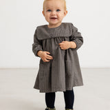Houndstooth dress in brown-blue check with ruched bodice panel and long sleeves