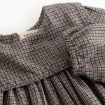 Houndstooth dress with ruffled collar and gathered chest detail, close-up