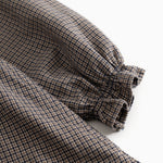 Children's dress with pied de poule pattern, puff sleeves with narrow cuffs and gathered hem.