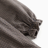 Children's dress with pied de poule pattern, puff sleeves with narrow cuffs and gathered hem.