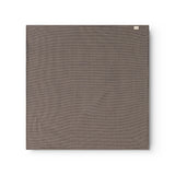 Airo scarf with houndstooth pattern in dark brown and blue, folded square