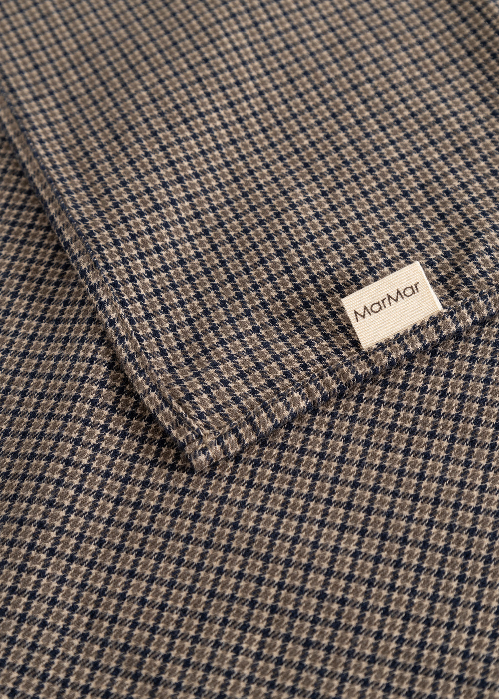 Airo scarf with houndstooth pattern and label, folded corner in brown and blue