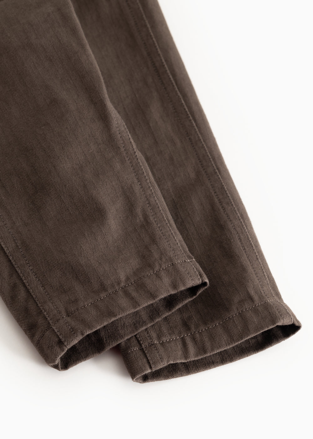 Brown baby pants with stitching on the pant legs and straight legs