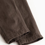 Brown baby pants with stitching on the pant legs and straight legs