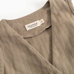 Brown boys' vest with collar and visible brand label at neck opening.