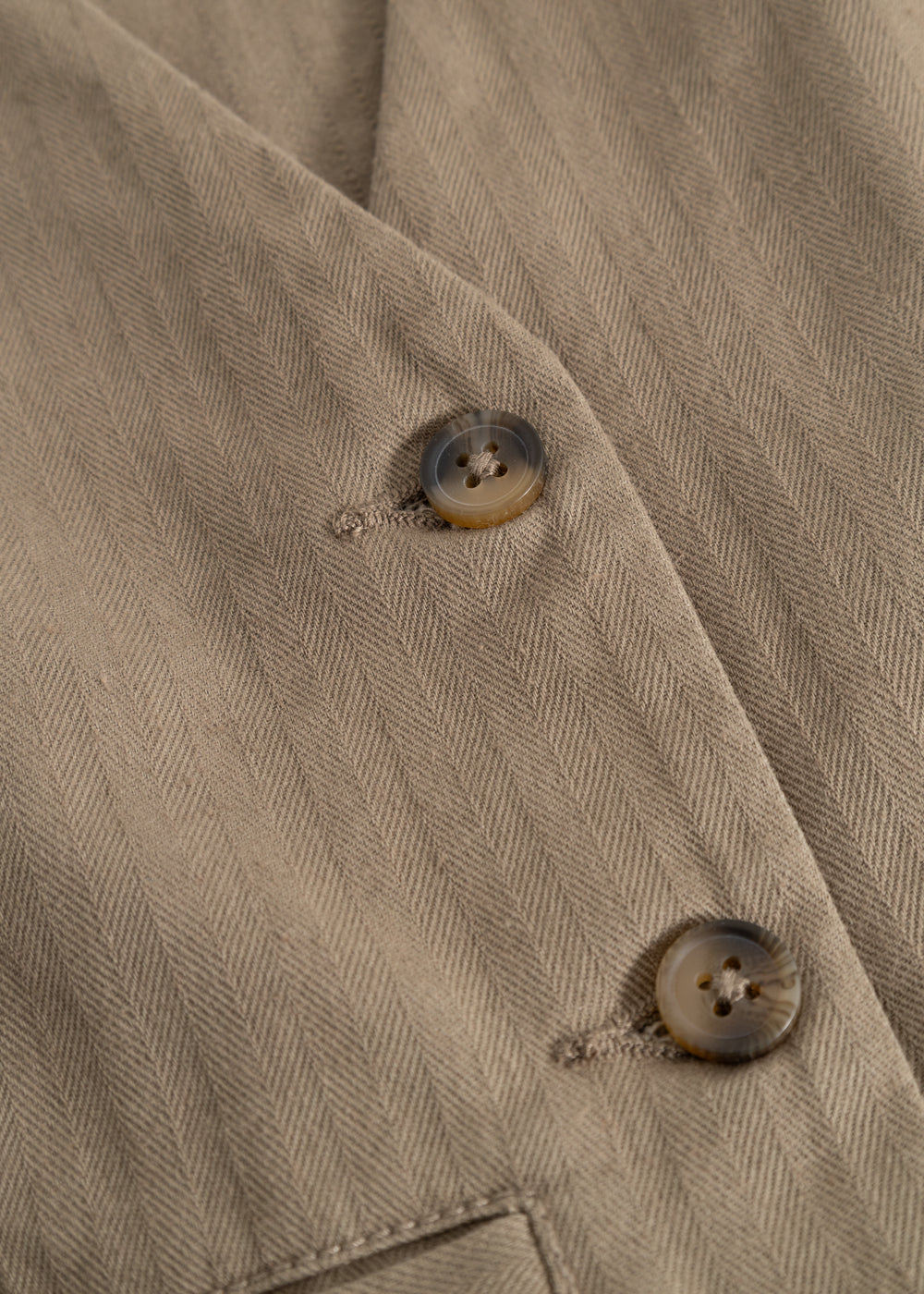 Brown boys' vest with buttons and diagonal pattern on the front fabric.