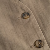 Brown boys' vest with buttons and diagonal pattern on the front fabric.