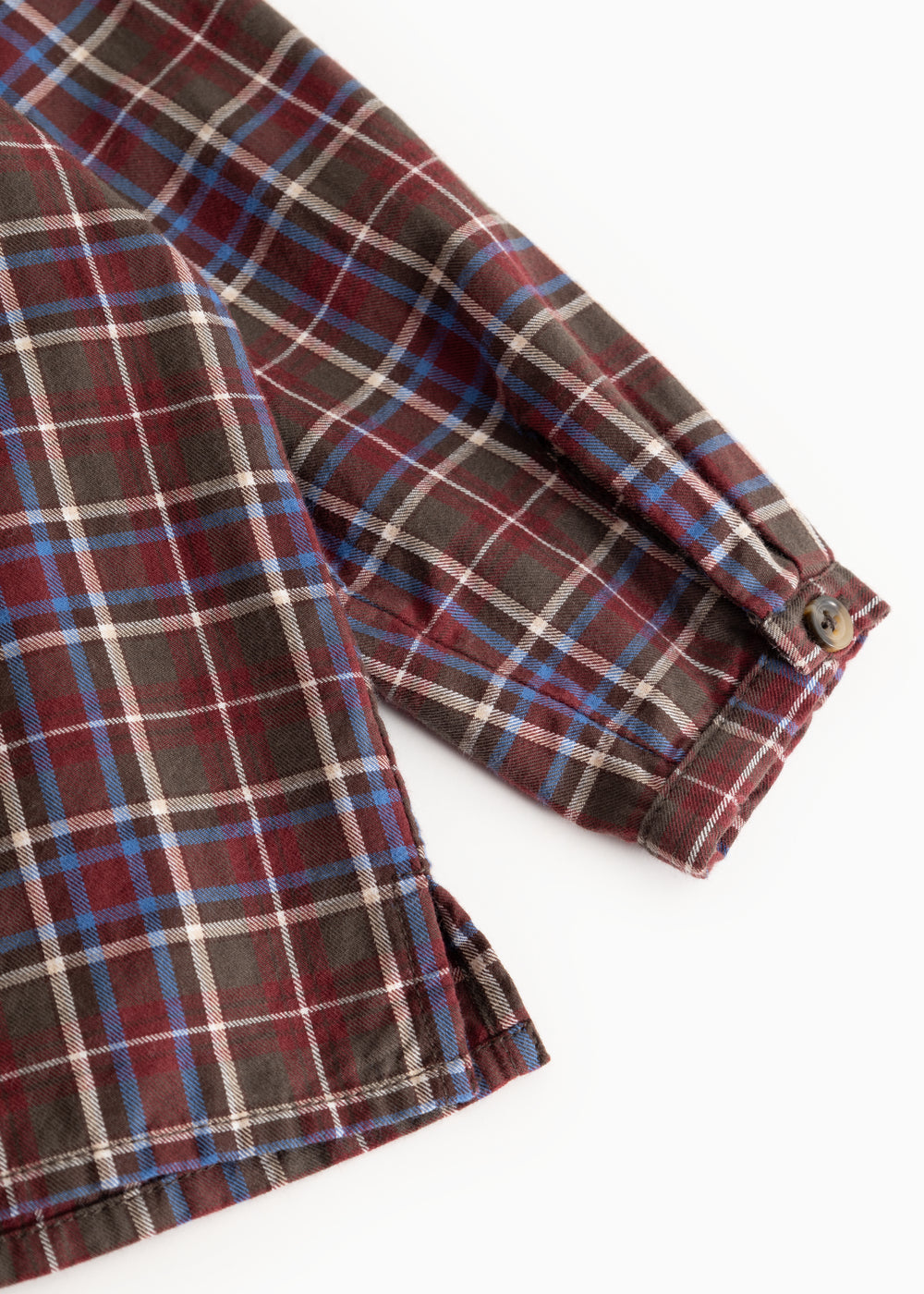 Checkered shirt sleeve with button cuff and pattern in brown, red, and blue
