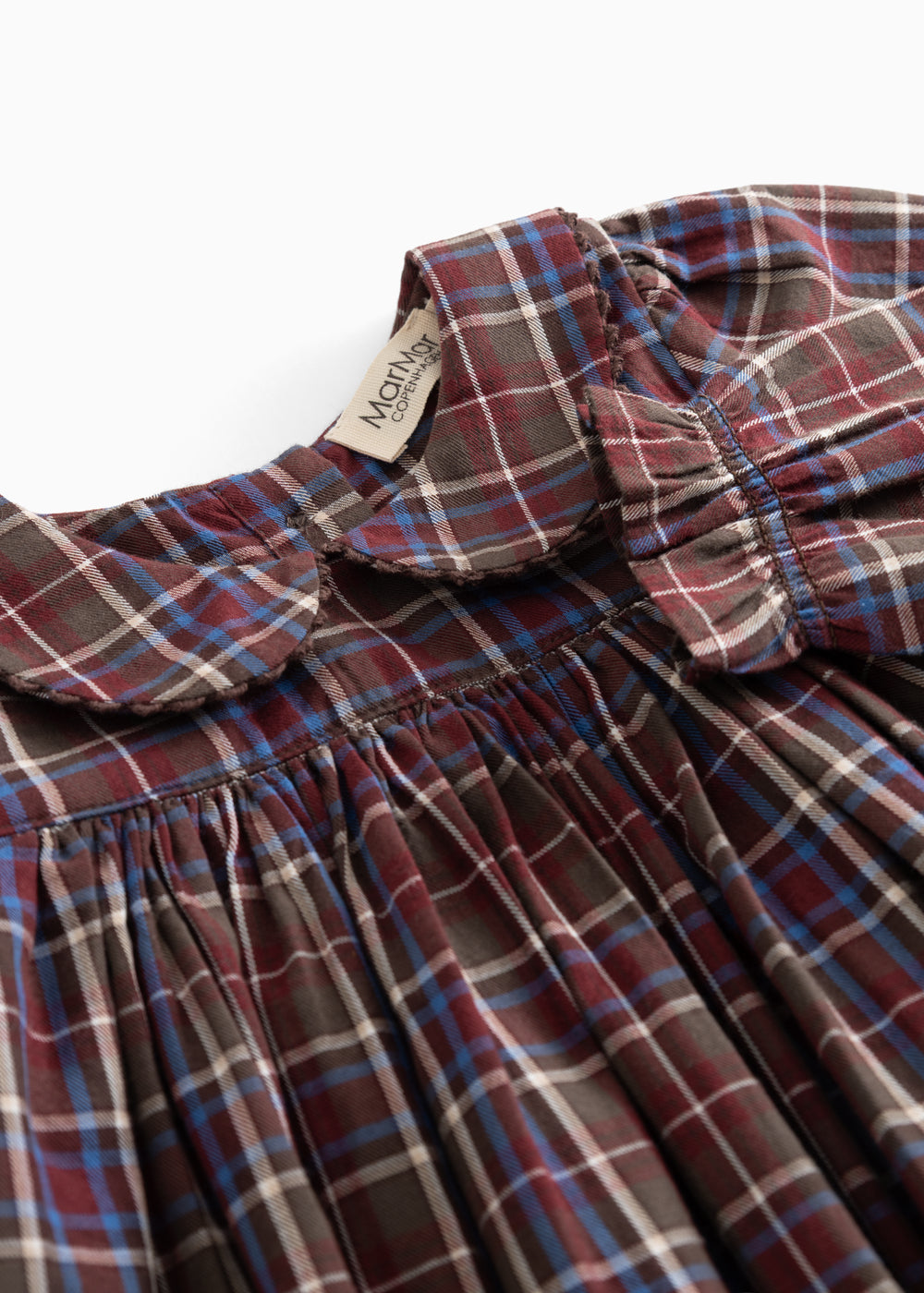 Tiered dress: collar and button closure at front with smocking detail at neckline