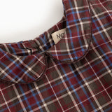 Detail of dark checkered dress with collar and button closure