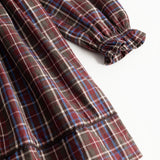 Dark checkered dress with long sleeves and gathered cuffs and hem
