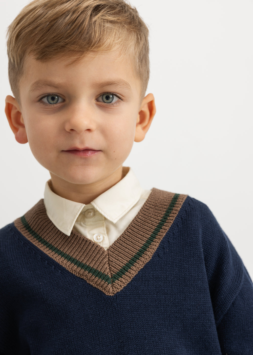 Light cream children's shirt with collar and button closure, worn by child
