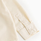 Light cream cuff with button and seam details at sleeve end