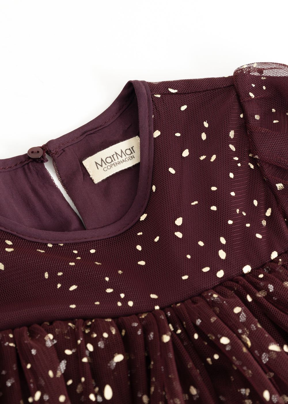 Dress with round neckline and label; dark burgundy with gold-colored dots