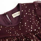 Dress with round neckline and label; dark burgundy with gold-colored dots