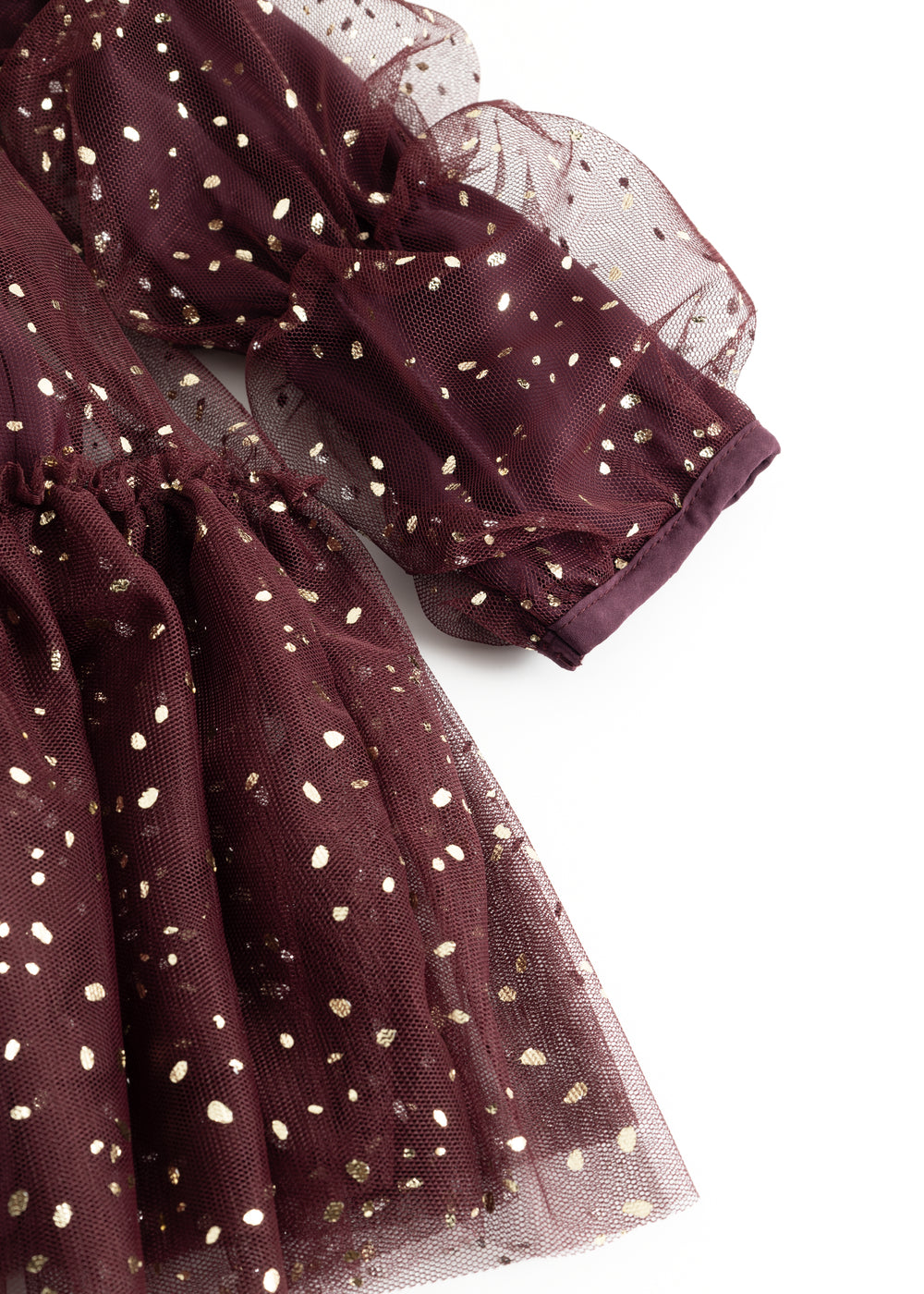 Sleeves and skirt in dark burgundy with gold-colored dots