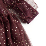 Sleeves and skirt in dark burgundy with gold-colored dots