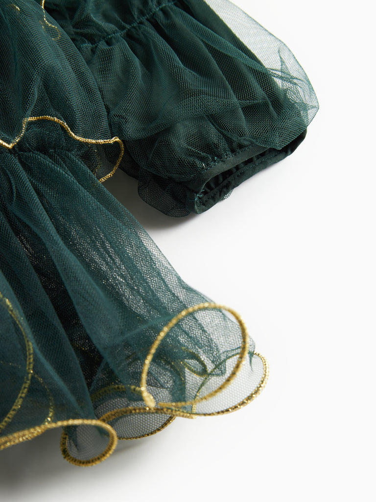 Dark green tulle dress with ruffle layers and gold trim at the hem