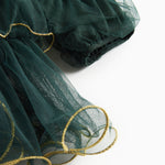 Dark green tulle dress with ruffle layers and gold trim at the hem