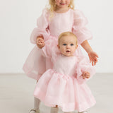 Pink tulle dress with voluminous sleeves and layered skirt