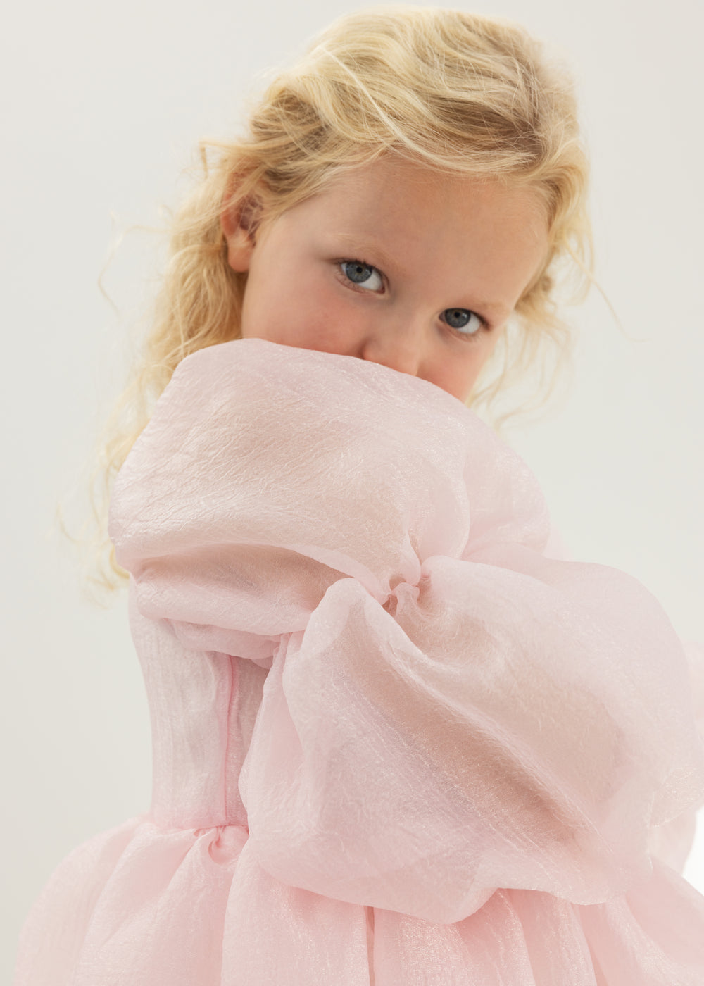 Pink dress with large tulle sleeve and soft ruffle at the upper body
