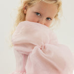Pink dress with large tulle sleeve and soft ruffle at the upper body