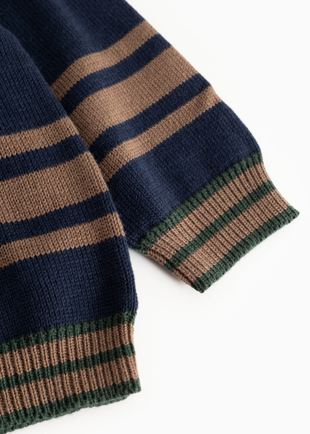 Dark blue knit sweater with striped cuffs in brown, blue, and green.