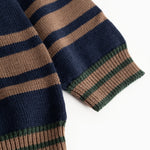Dark blue knit sweater with striped cuffs in brown, blue, and green.