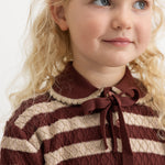 Knitted sweater with brown-red and cream stripes and a bow at the neckline