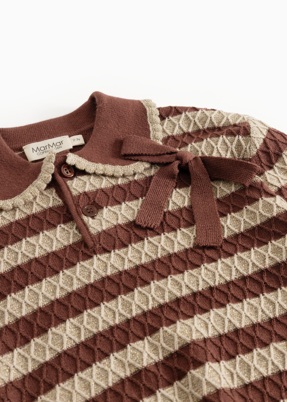 Knitted sweater with reddish-brown and cream stripes, buttons and bow at the neck