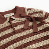 Knitted sweater with reddish-brown and cream stripes, buttons and bow at the neck