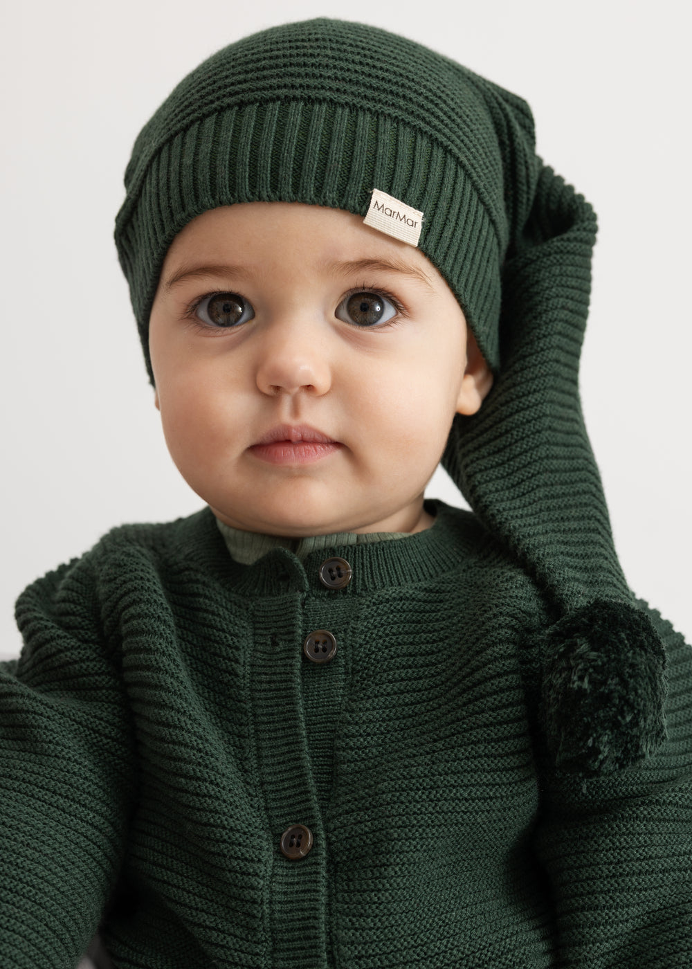 Dark green knitted cardigan for child with button closure and rib knit