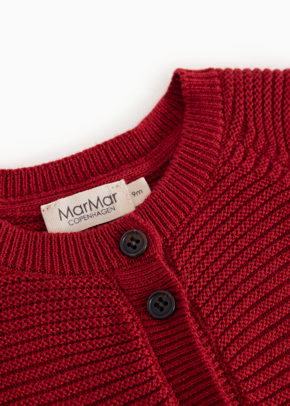 Red knitted cardigan with buttons at the front and MarMar label at the neckline