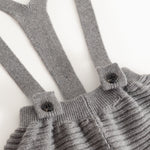 Gray suspenders with buttons and gathered chest piece on knitted pants
