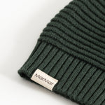 Knitted dark green elf hat with MarMar label and ribbed edge