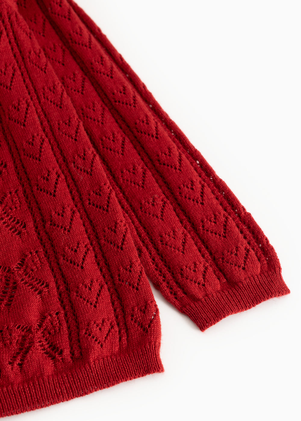 Cherry red knitted cardigan sleeve with ribbed cuff and openwork knit pattern