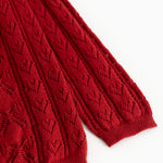 Cherry red knitted cardigan sleeve with ribbed cuff and openwork knit pattern