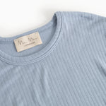 Light blue long-sleeve T‑shirt, crew neck and tag at the collar.