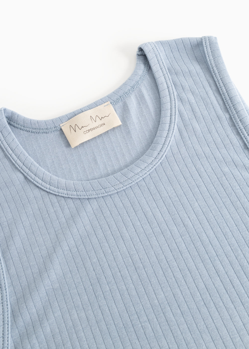 Light blue tank top with crew neckline, visible brand label, and rib pattern.